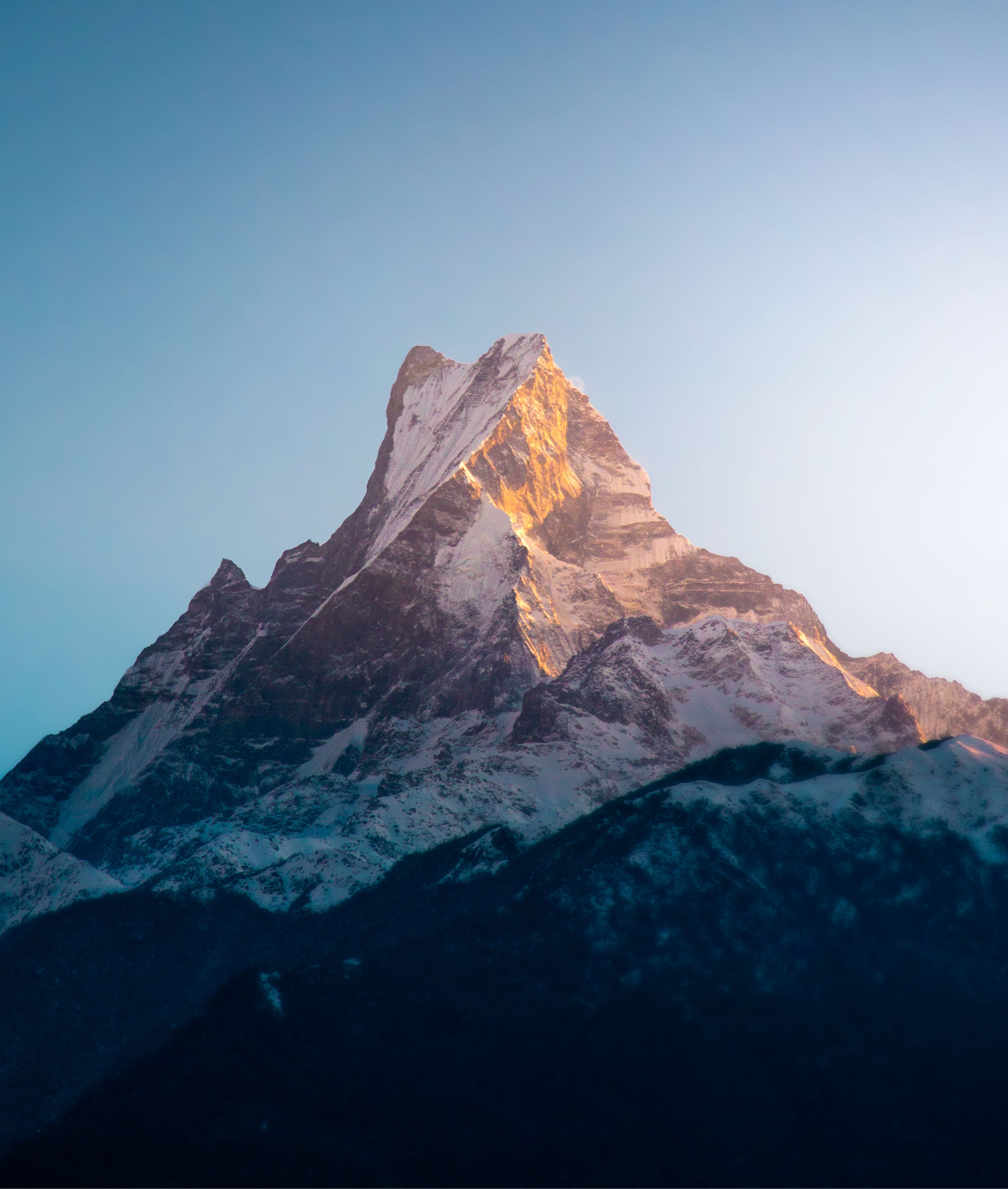 Snow-capped mountain peak with a clear blue sky