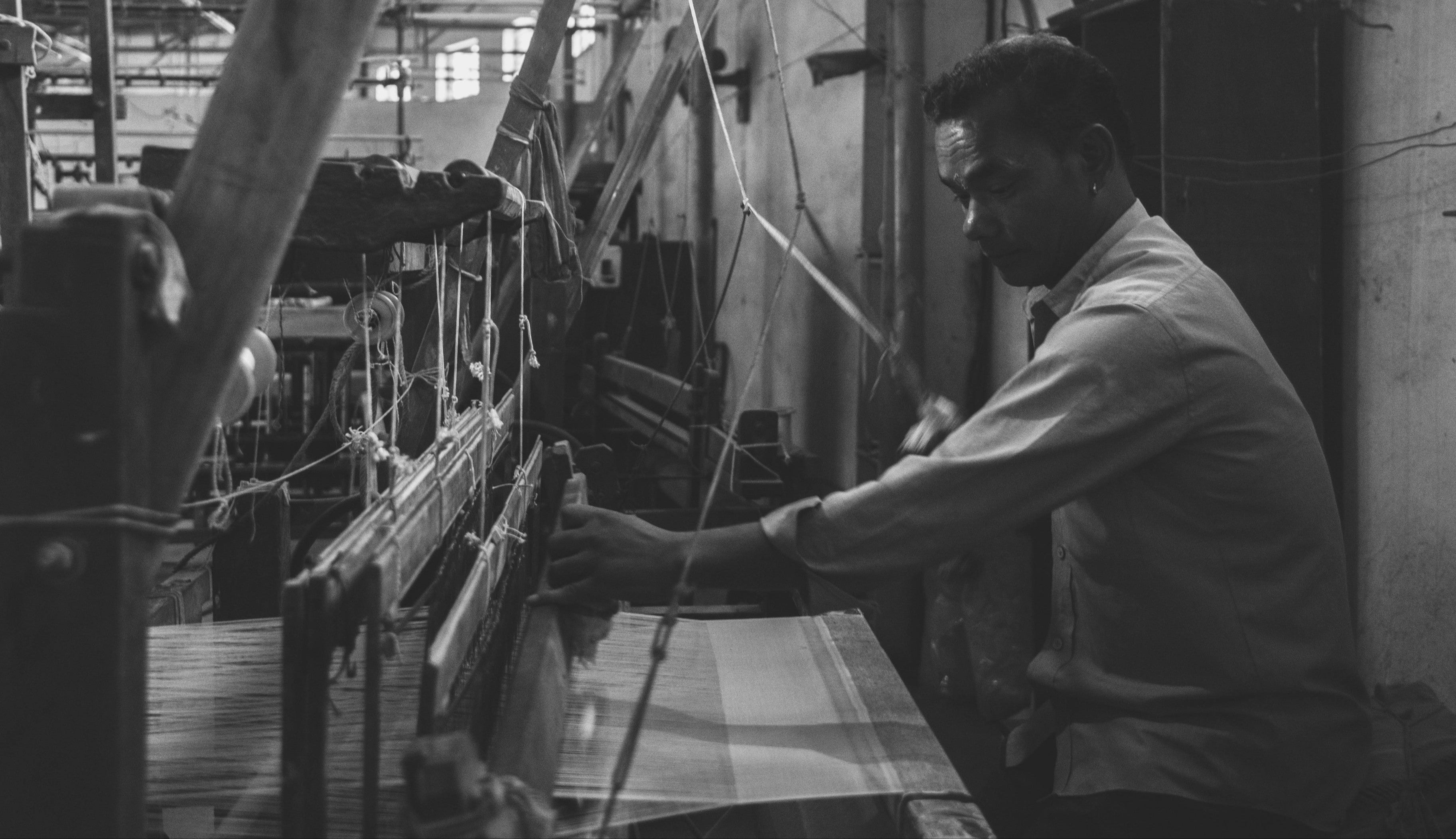 Man operating hand loom in Nepal